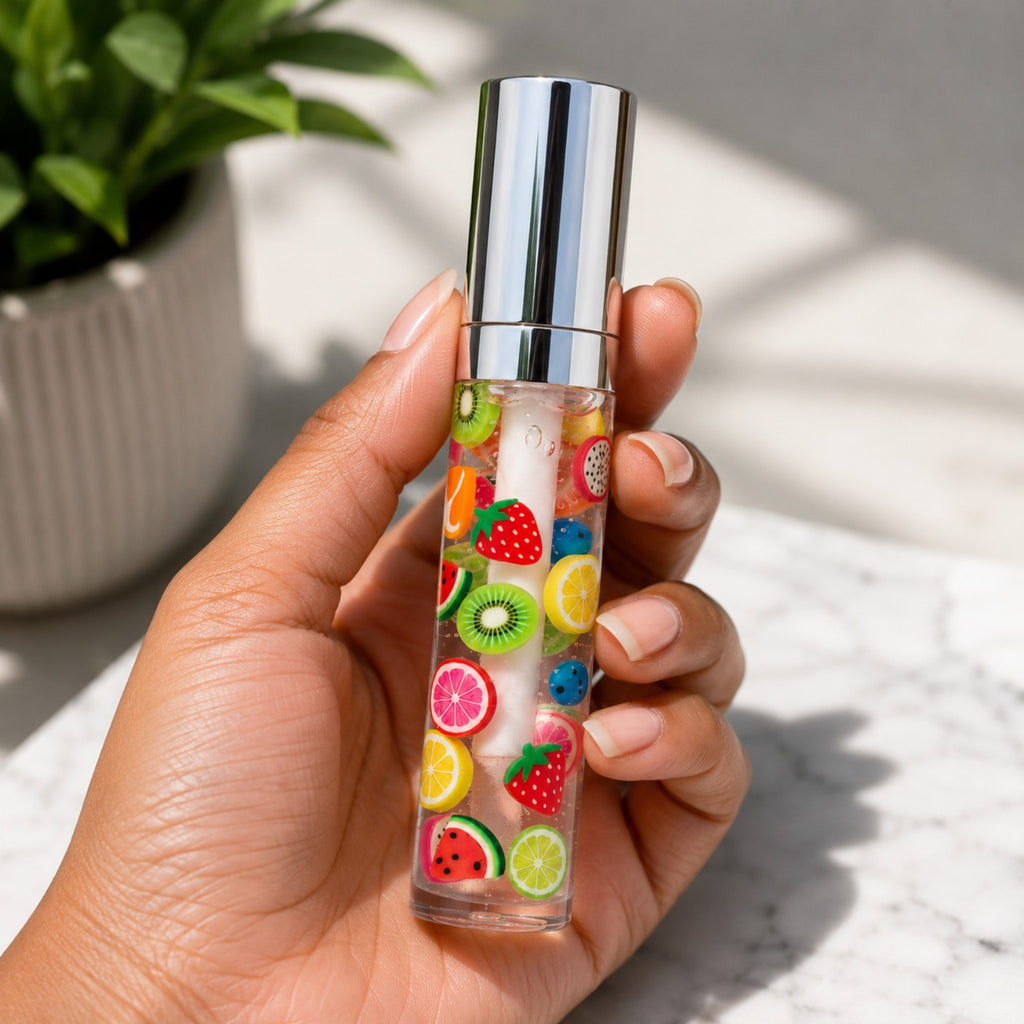 Hand holding an 8 mL PL3 Fruity Drip clear lip gloss tube